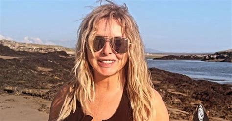 Carol Vorderman spills out of unzipped wetsuit in EYE